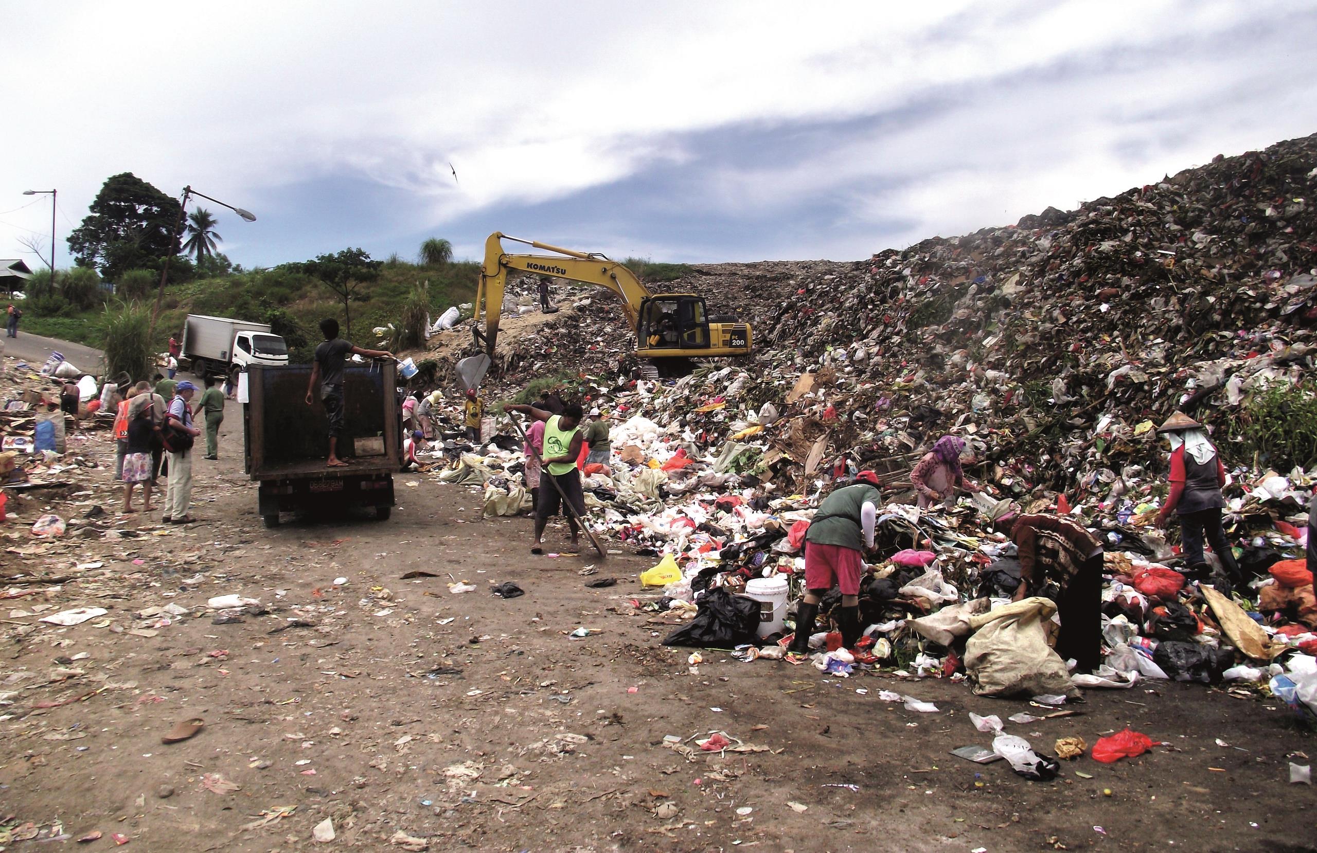 Workers removing low value items (Plastic bottles) at the Manado landfill site