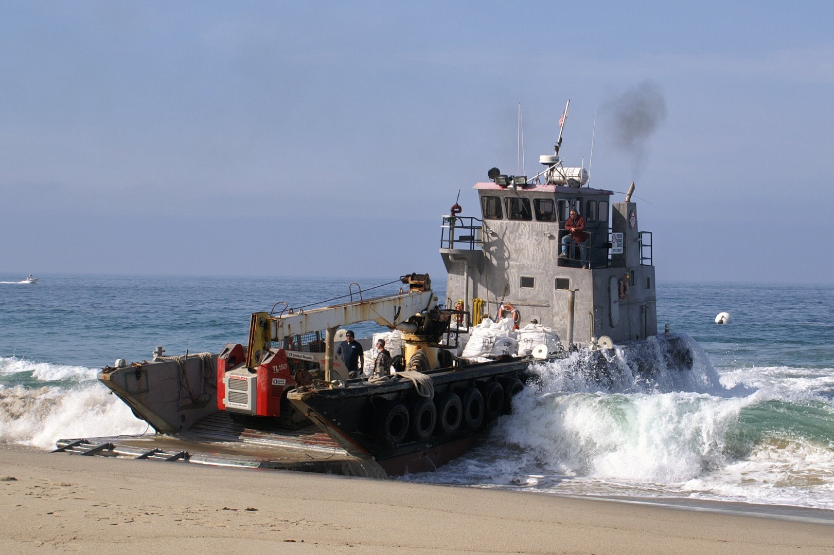 Waste being loaded onto a landing craft