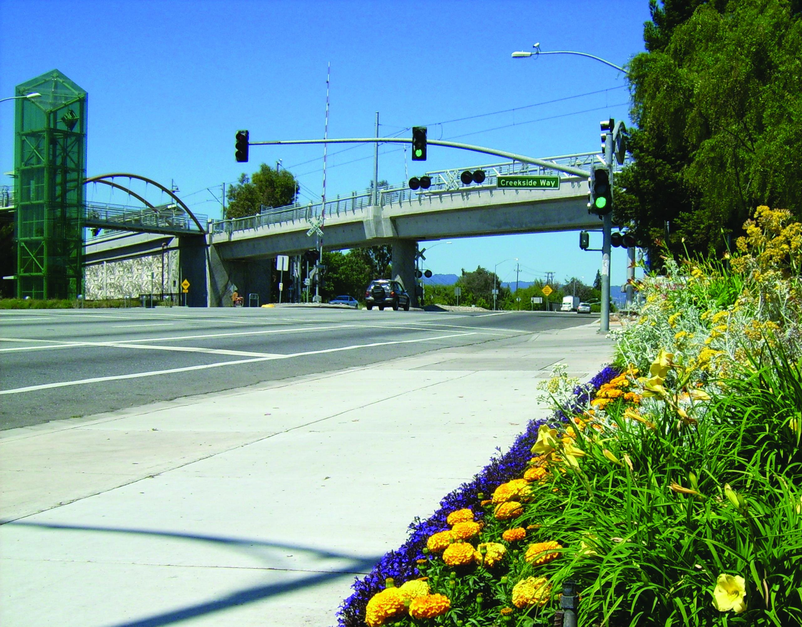 Shot of a bridge with flower beds in the foreground