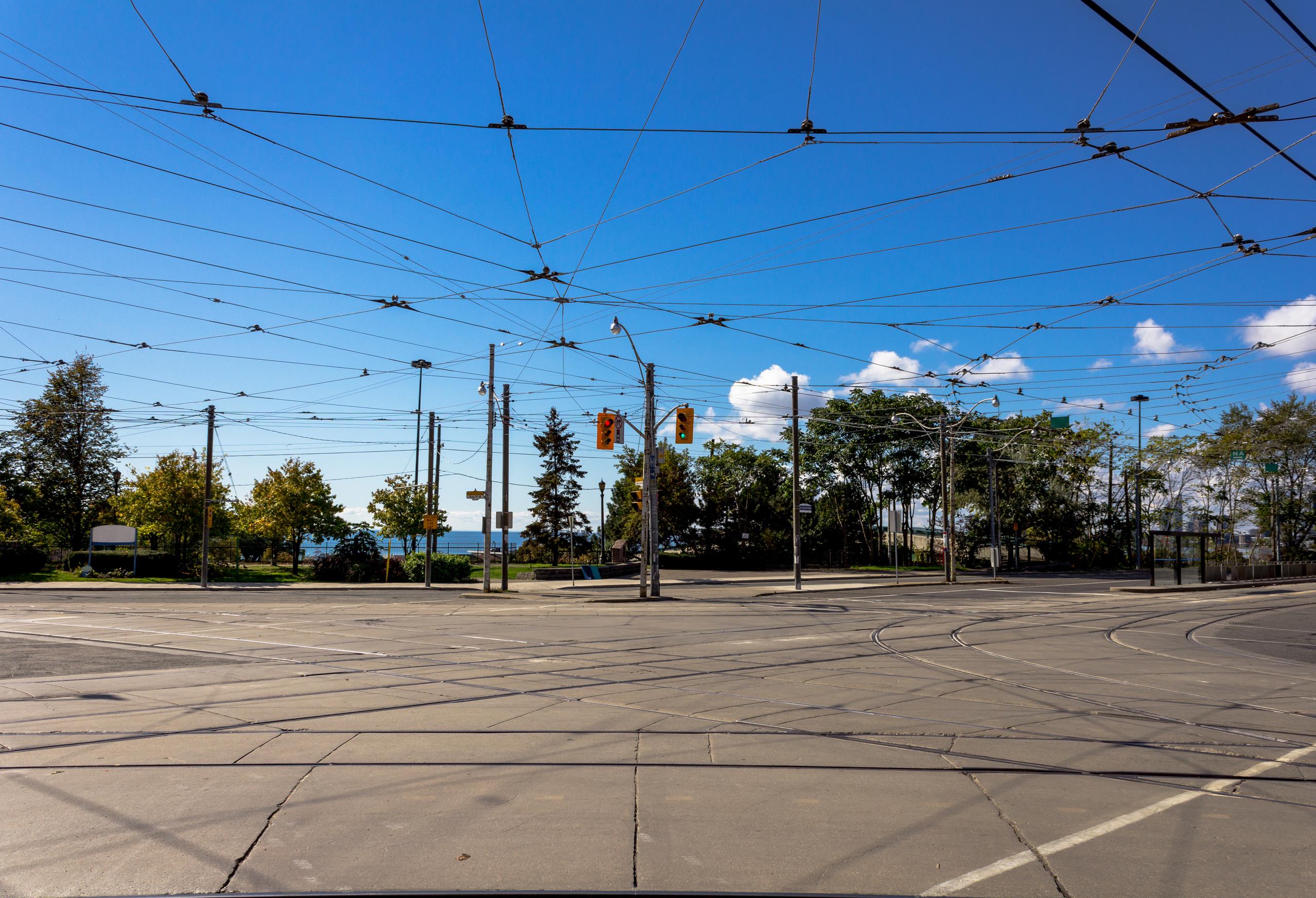An empty traffic junction with power cables running overhead