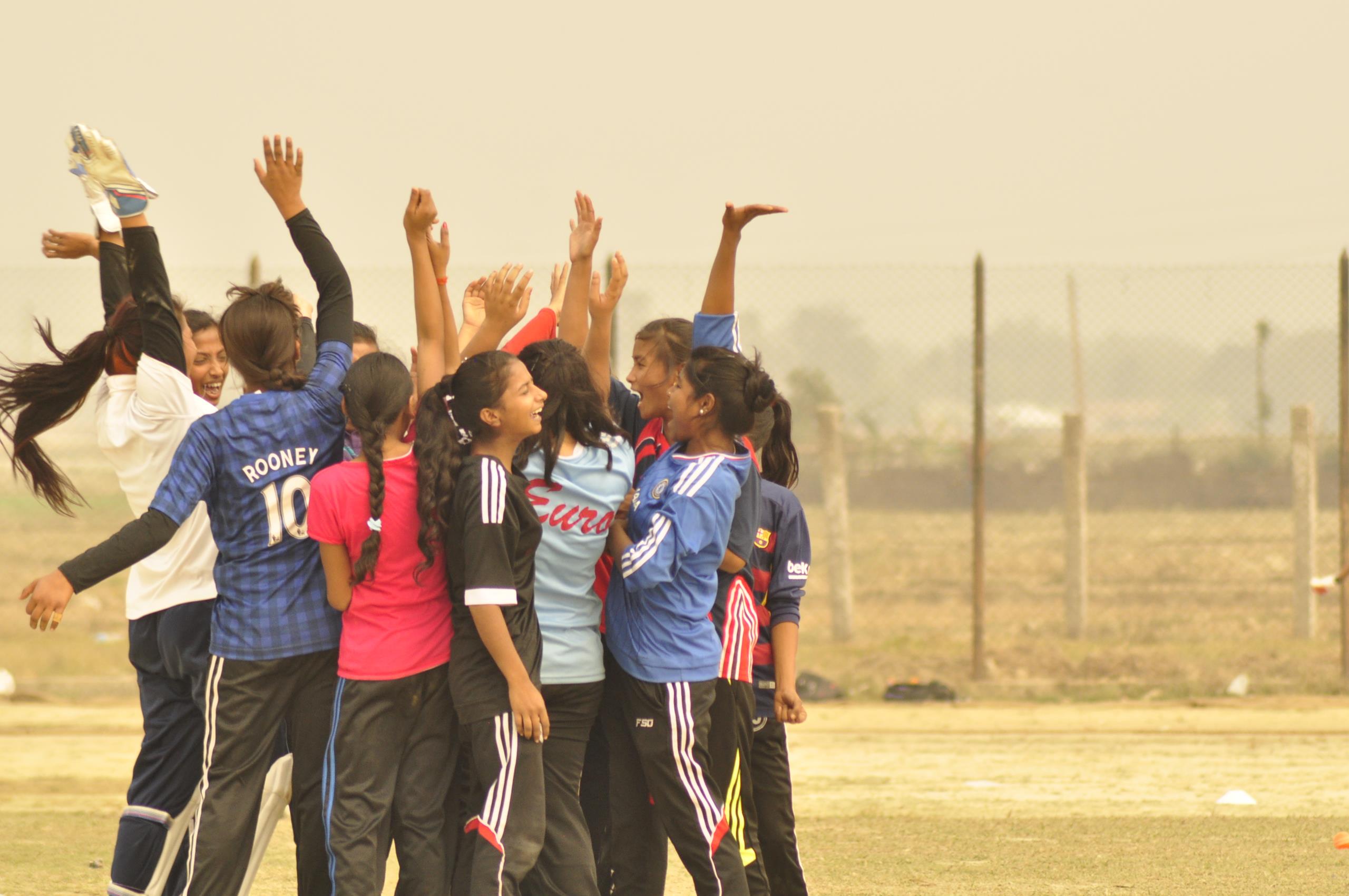 Girls celebrating after a cricket match