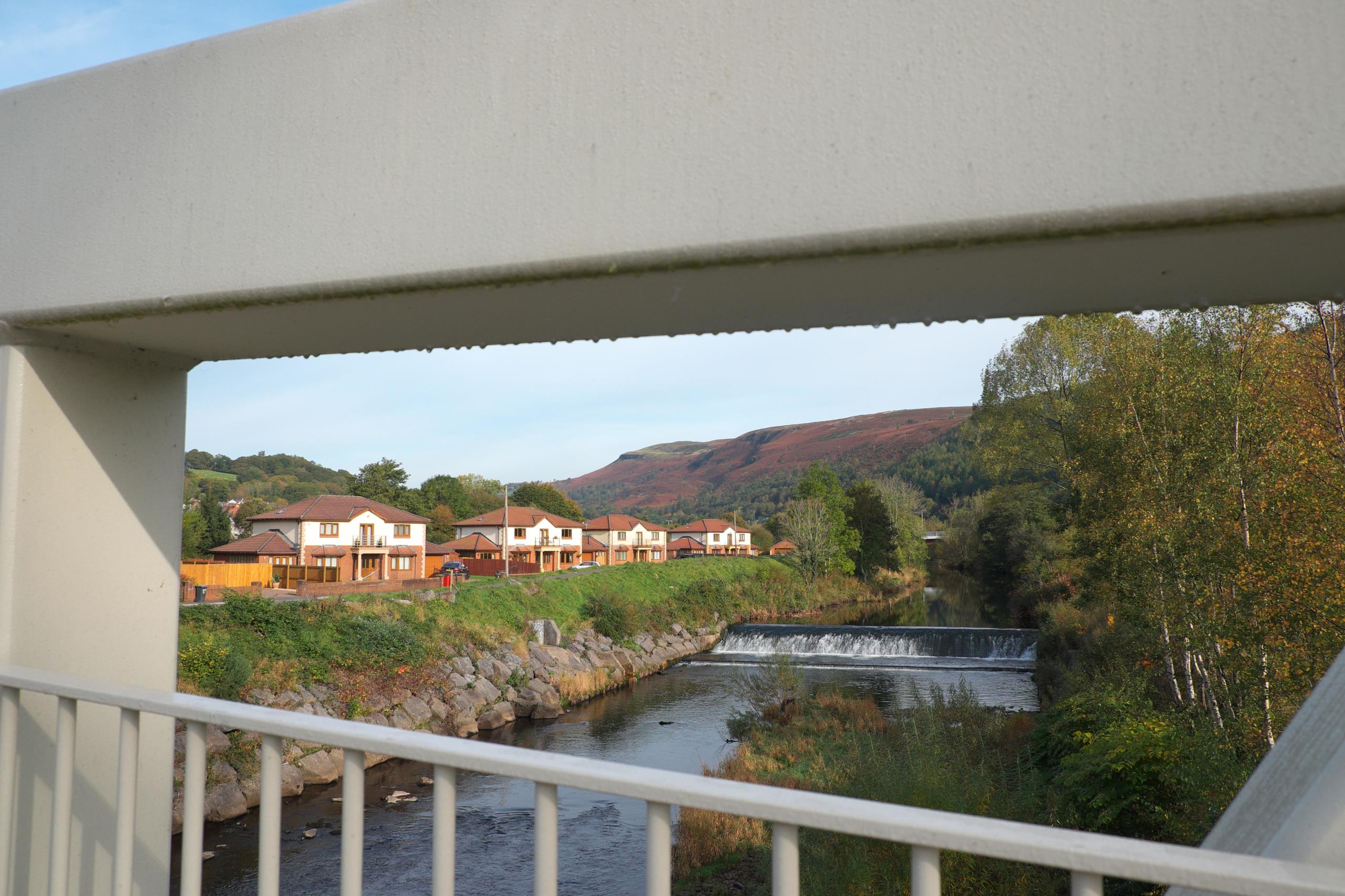 Modern detached houses beside the River Taff in Aberfan, Wales