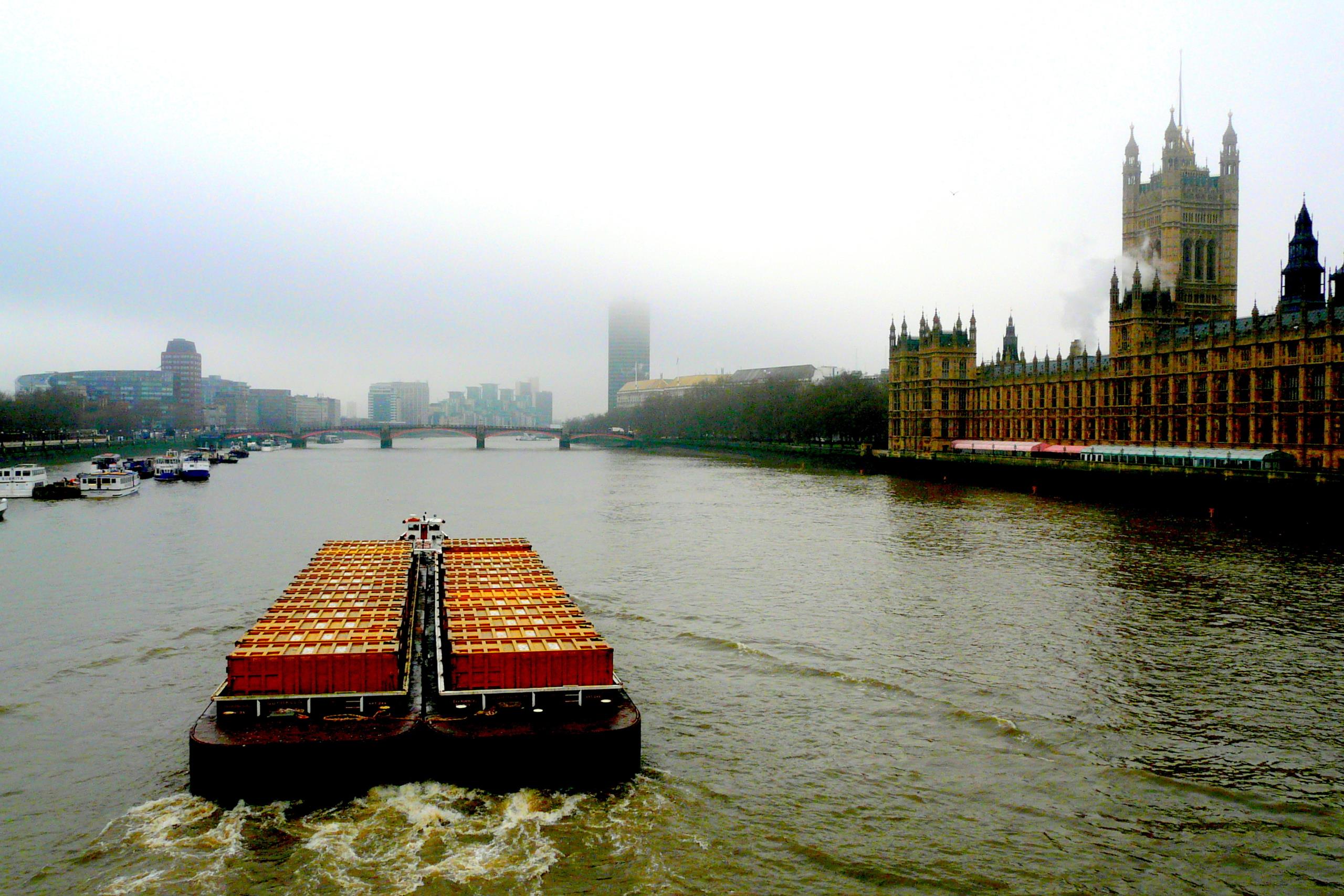 Boat pulling cargo on The River Thames