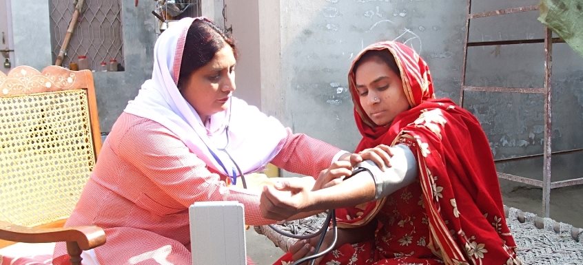 community midwife taking blood pressure
