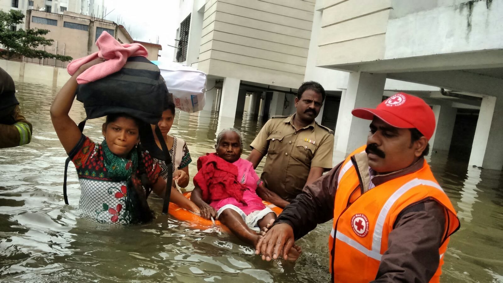 A family being helped by the Red Cross during the floods of South India in 2015