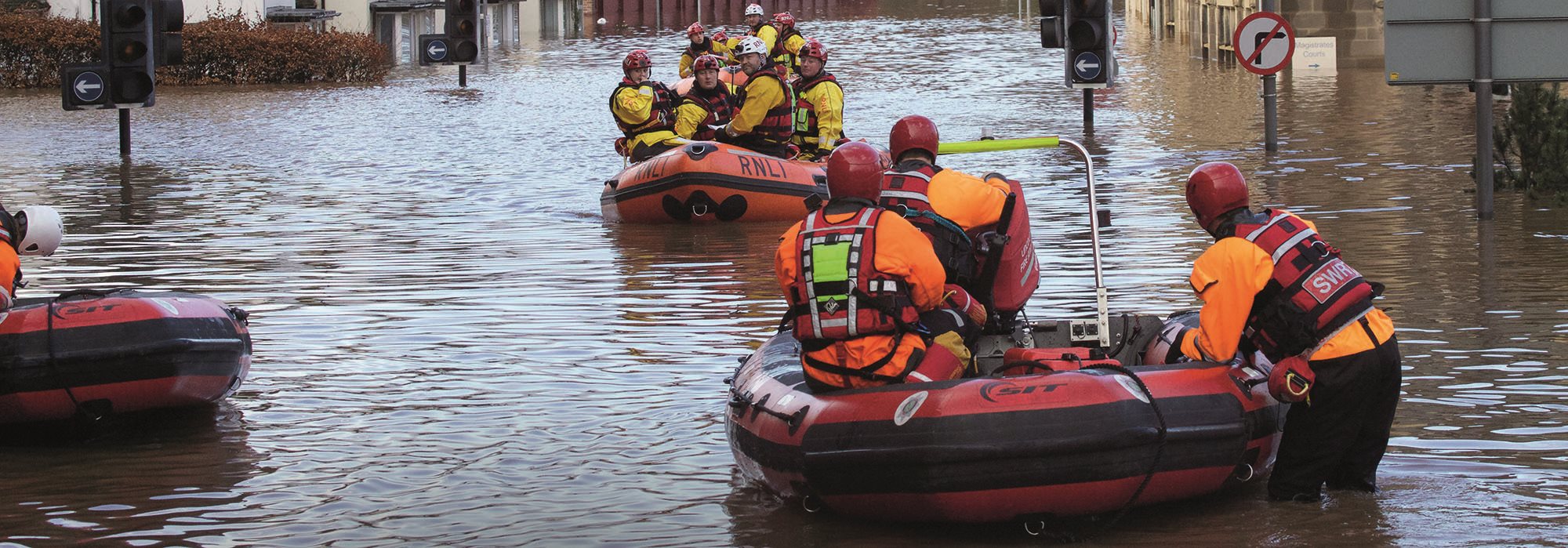 Emergency service people in boats during the Cumbria Floods