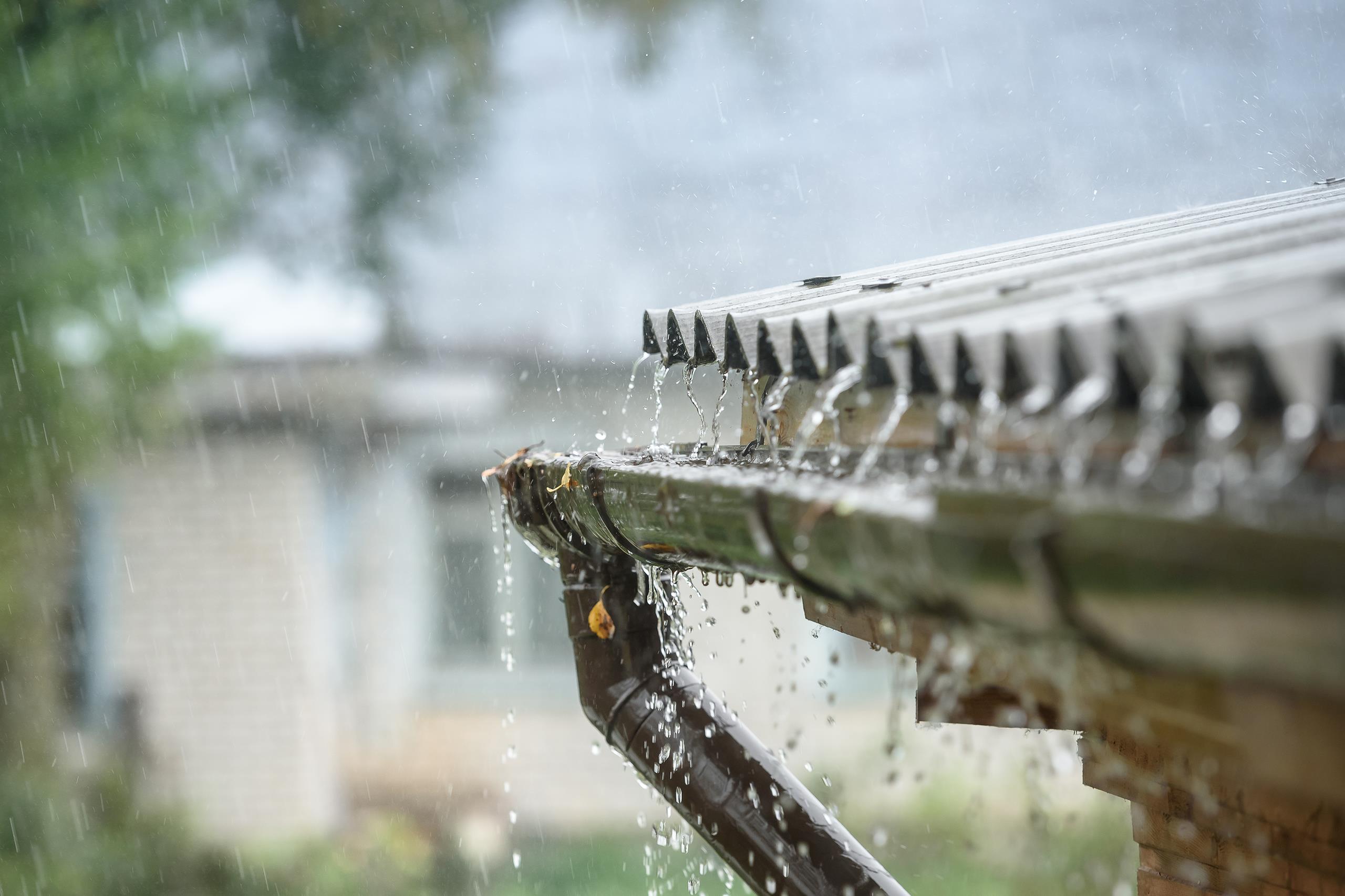 Heavy rainfall almost overflowing from a guttering system