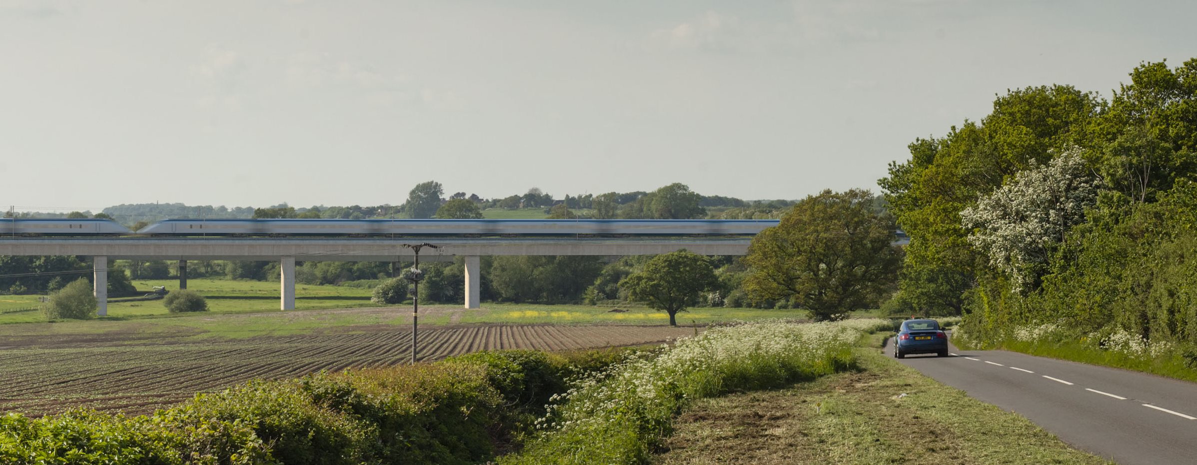 view of HS2 train crossing a rural road