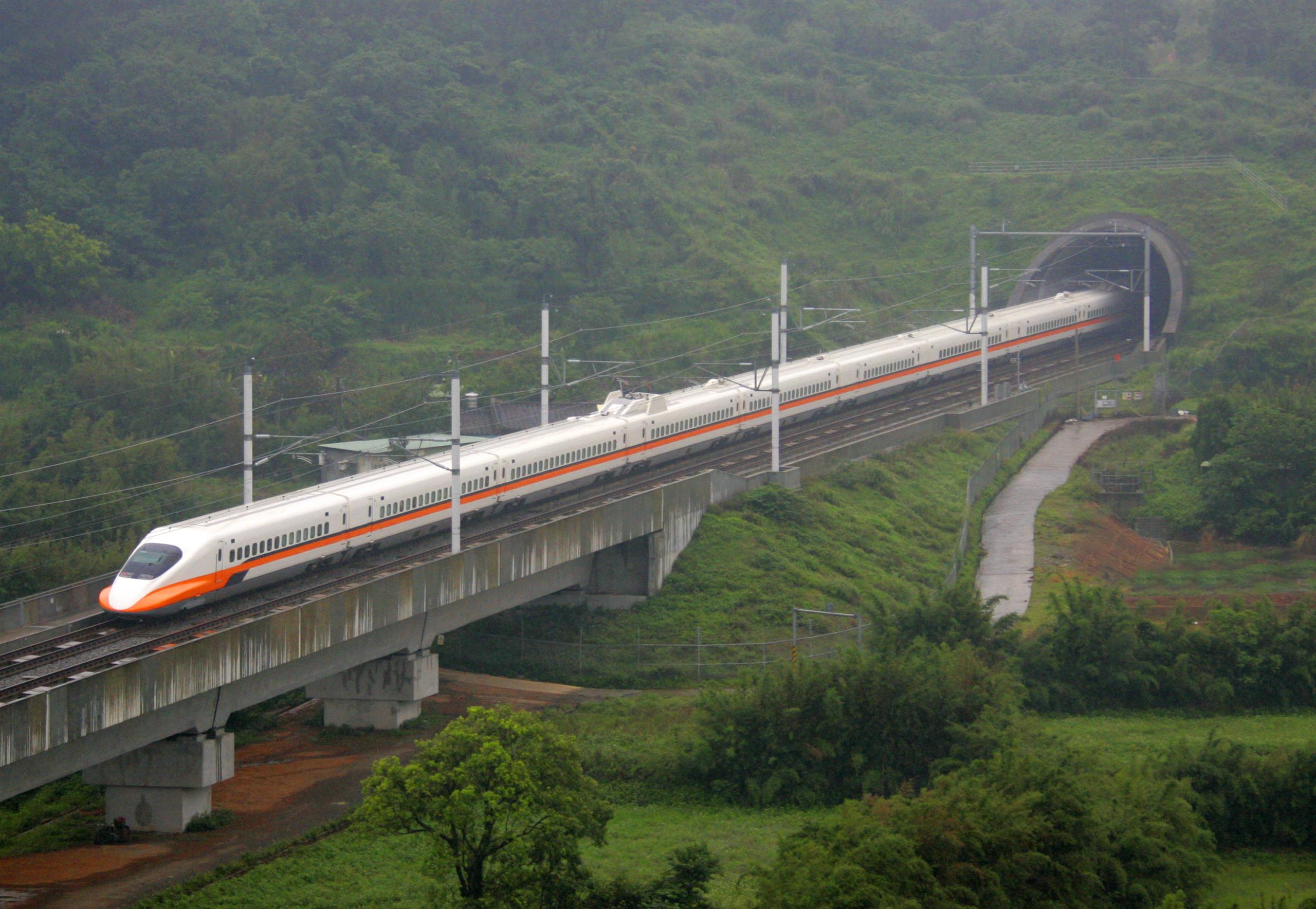 High speed train exiting tunnel approaching viaduct