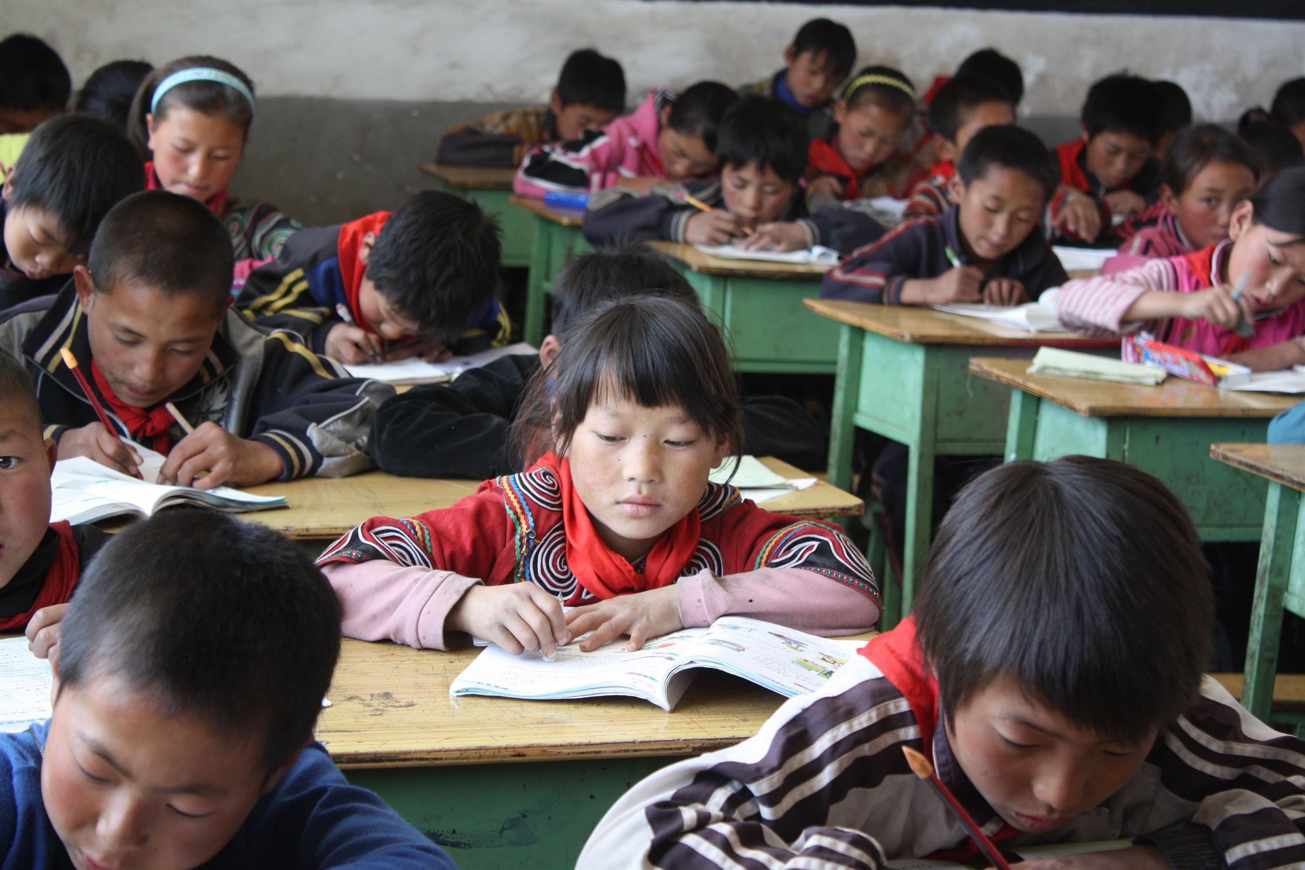 Children in a classroom taking a maths test