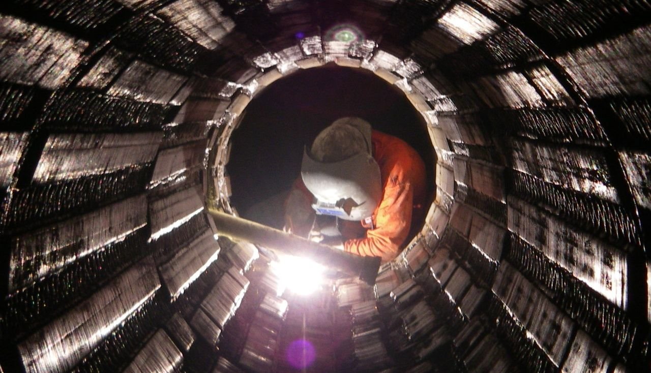 Workman welding on part of the inland feeder project