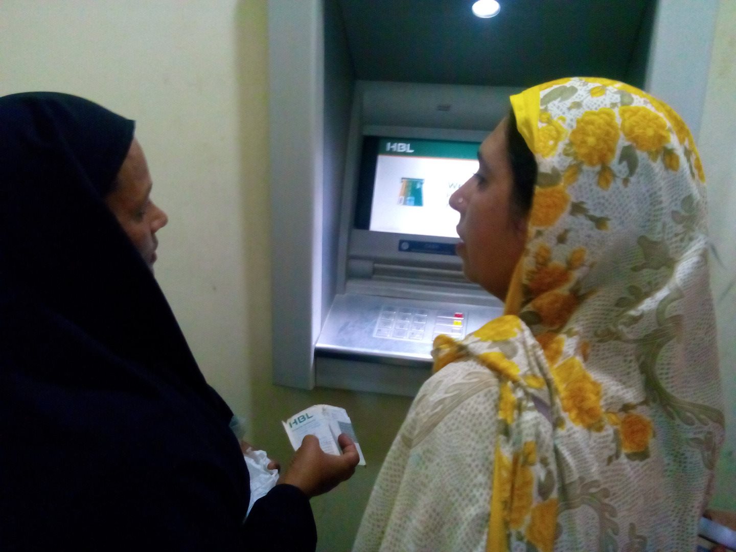 Two women at ATM in Pakistan