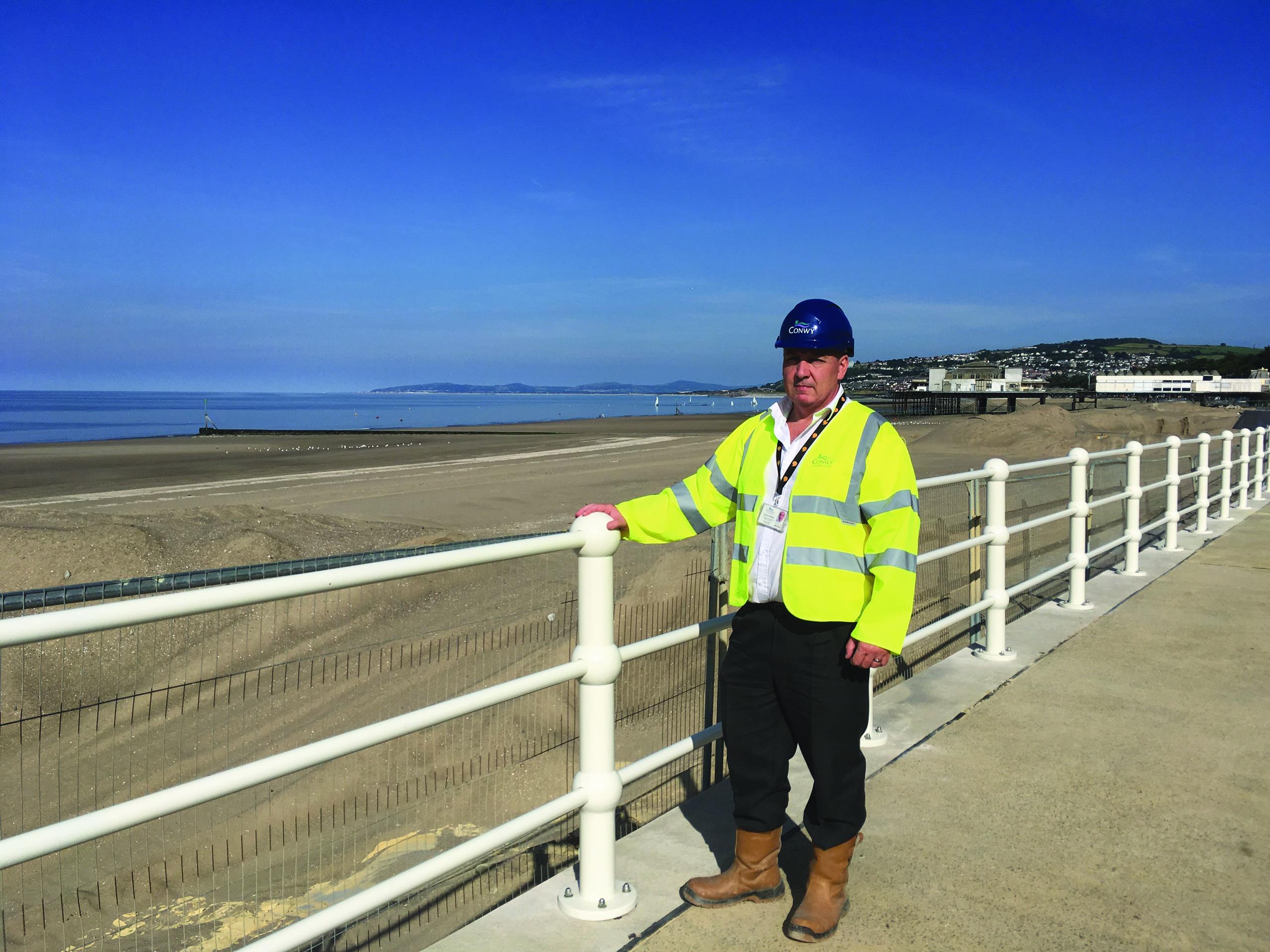 Councillor Geraint Edwards by the Colwyn Bay seafront restoration site