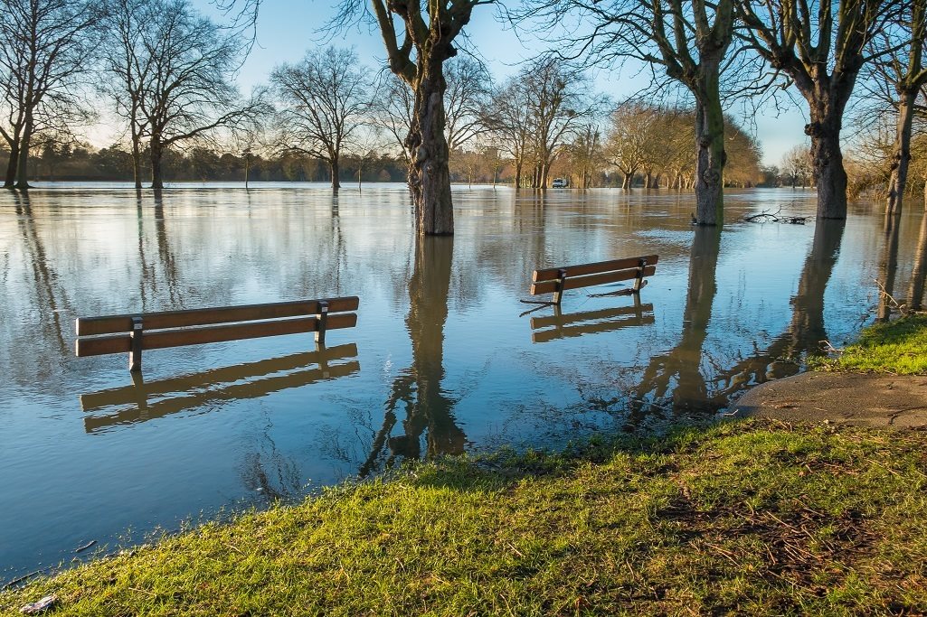 Flooded riverbank with benches