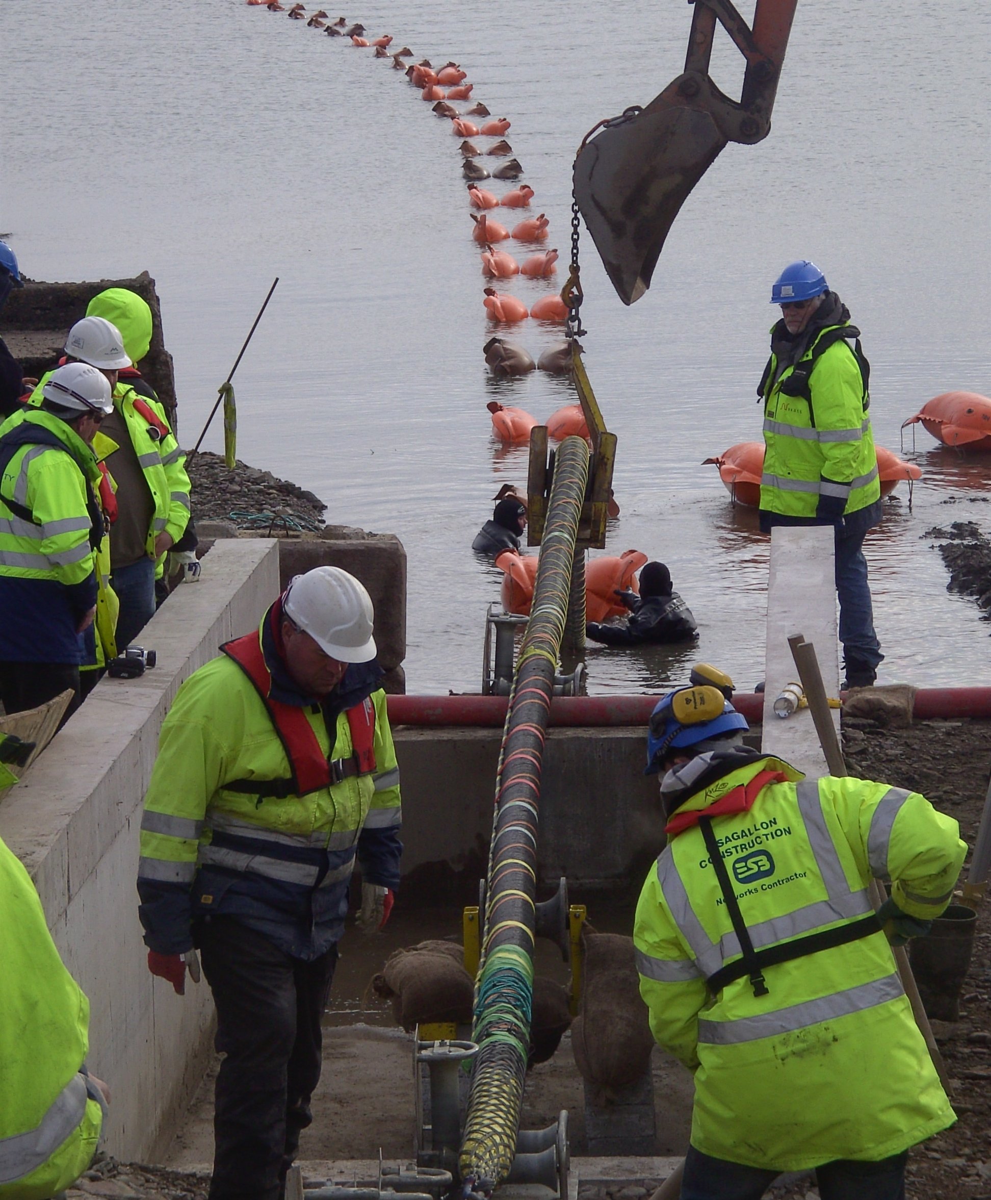 Construction workers installing undersea cable