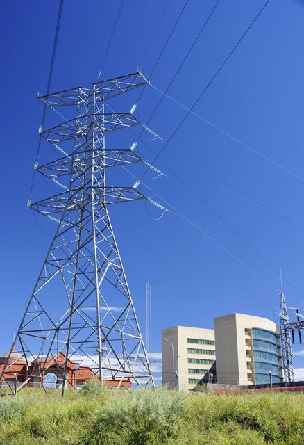Transmission pylon by town buildings