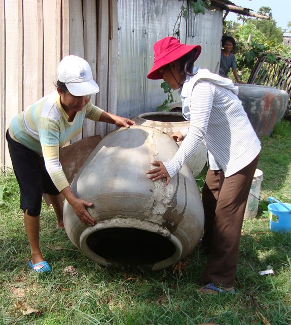 Women turn over household waterpot 