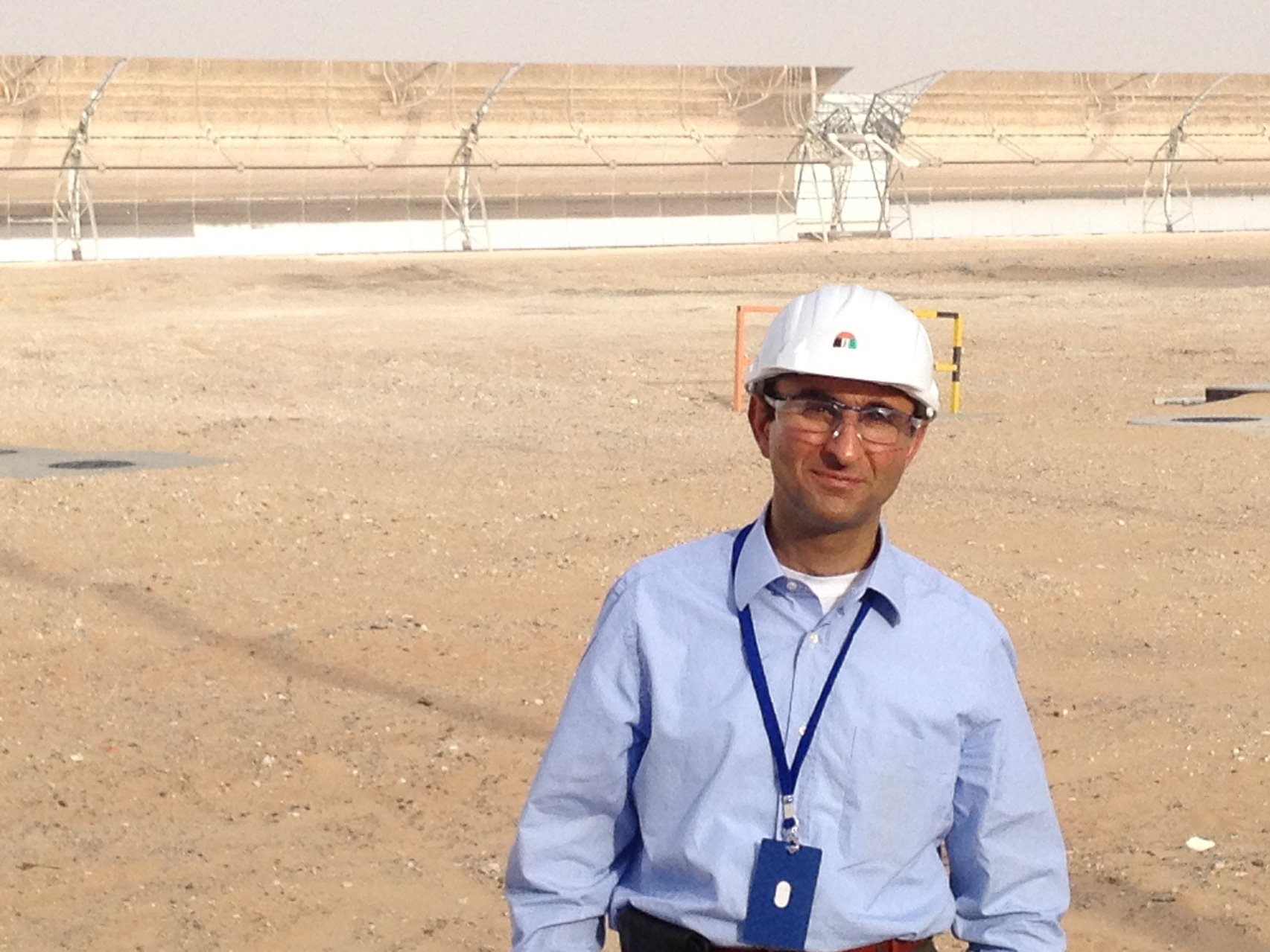 Viktor in front of the parabolic mirrors of Shams 1 concentrating solar power project in the United Arab Emirates.
